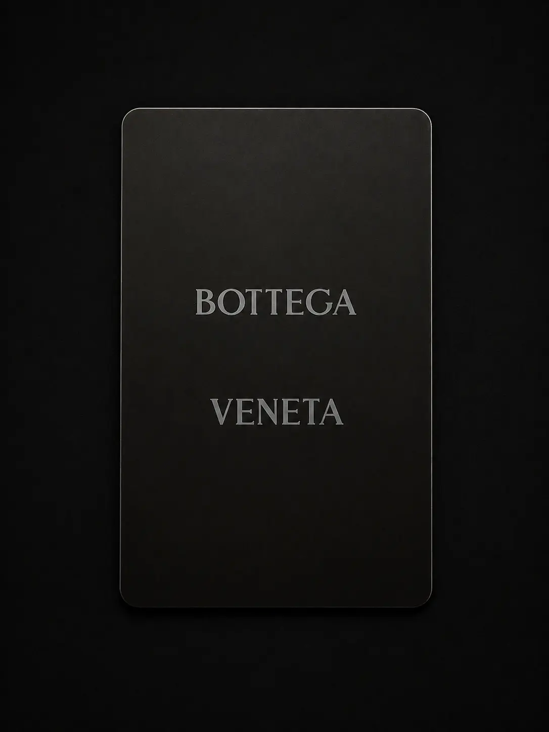 Front of a black Bottega Veneta connected metal card with silver marking