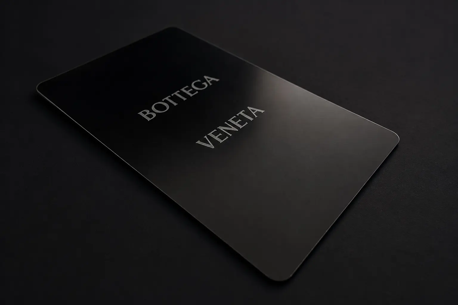 Low perspective view of the black Bottega Veneta metal card