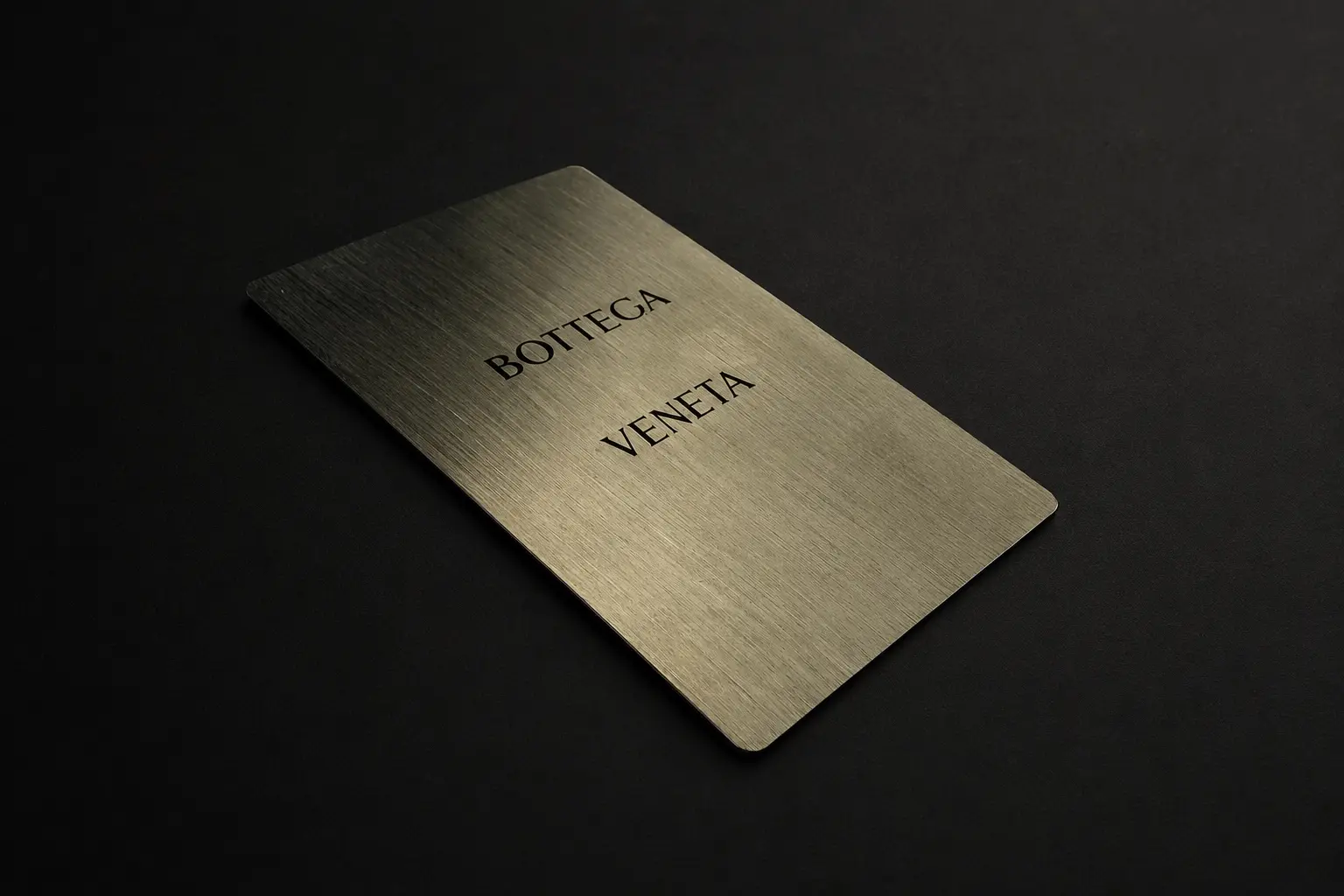Low perspective view of the champagne-tone Bottega Veneta metal card
