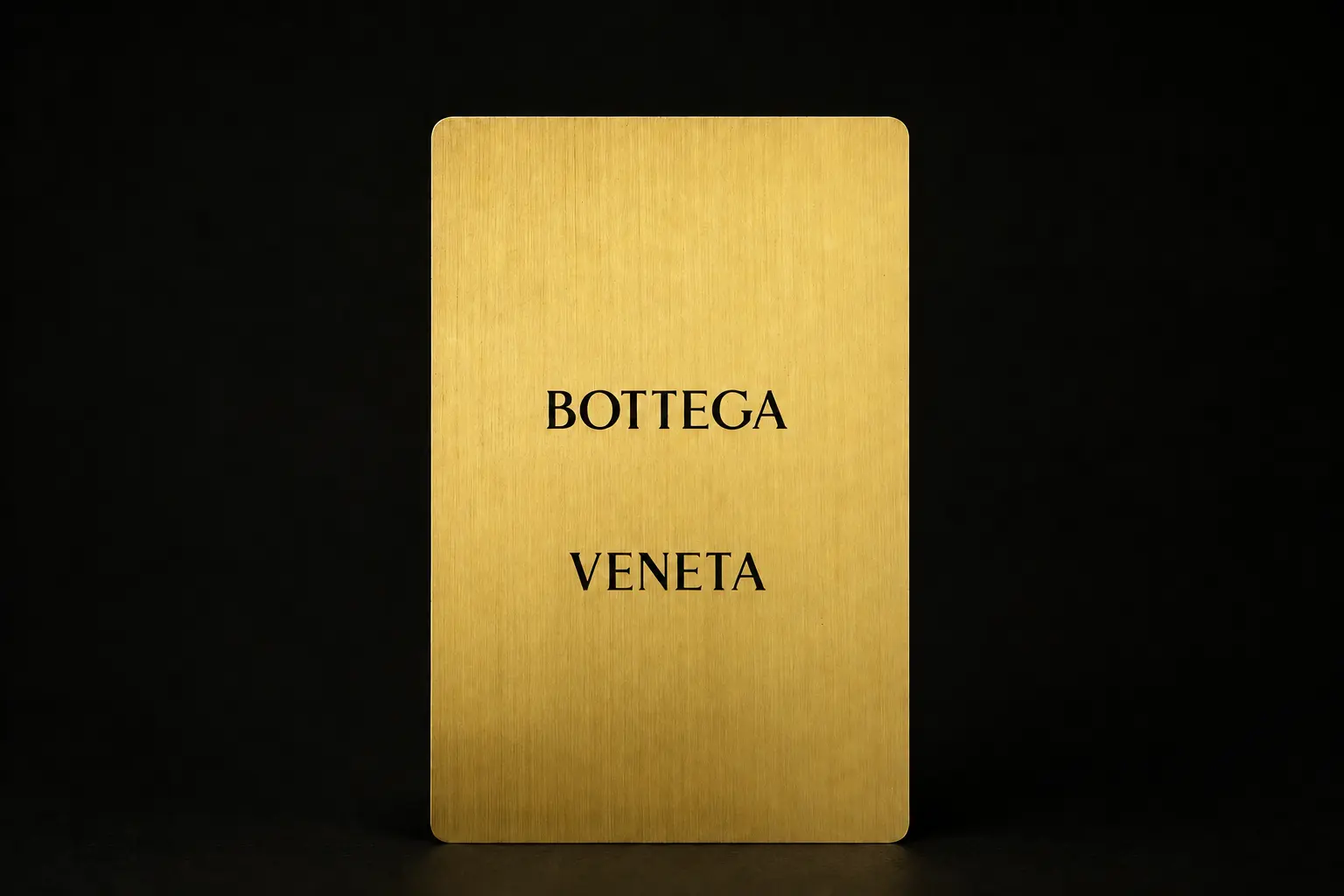 Front of a gold-tone Bottega Veneta connected metal card