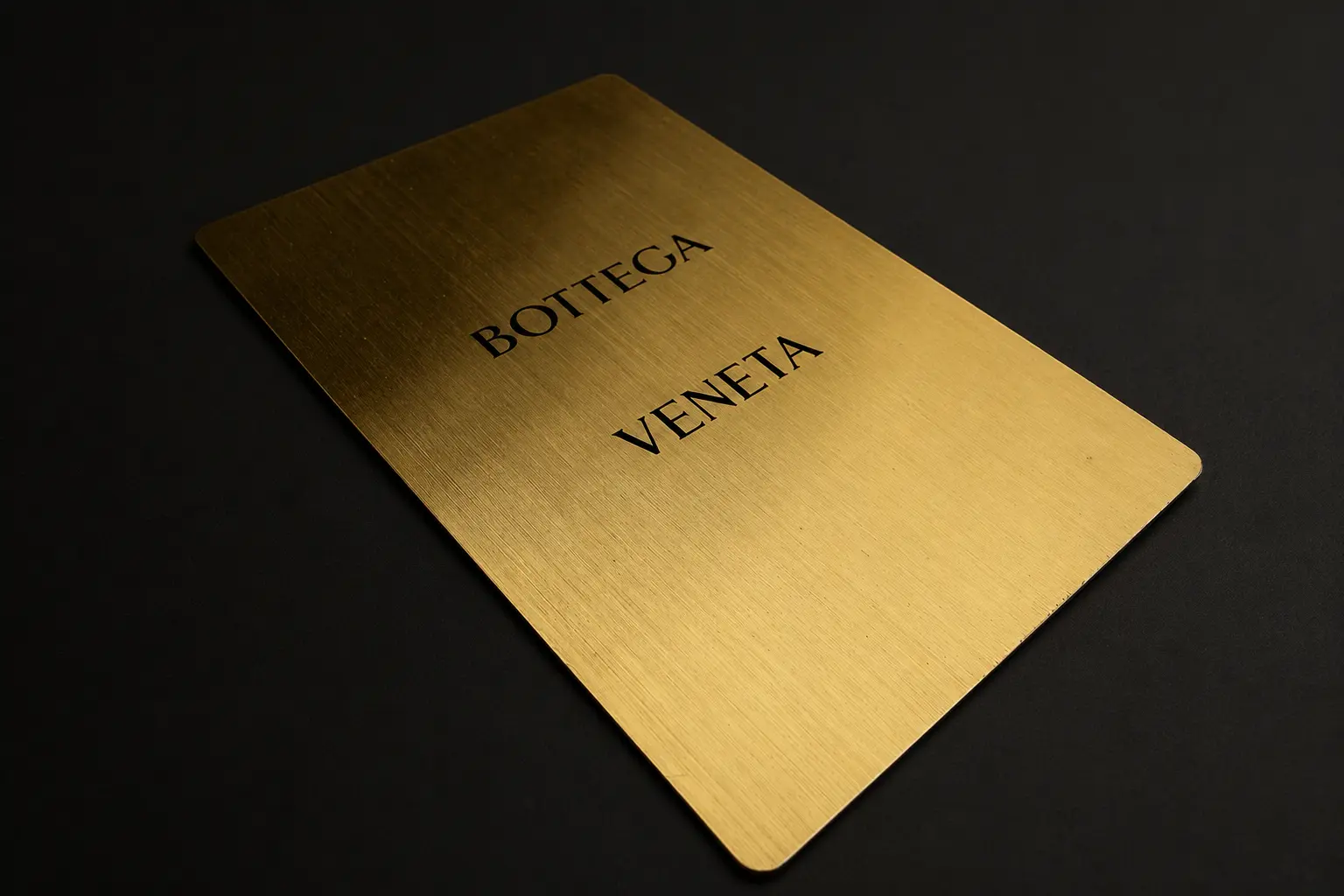 Bottega Veneta connected metal card in a gold-tone finish