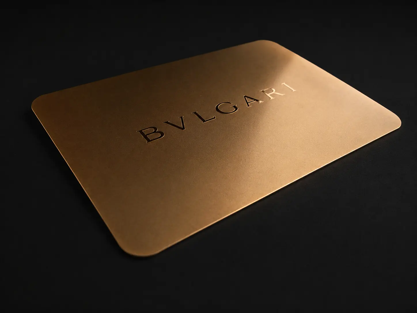 Bulgari connected warranty card in a satin gold-tone metal finish
